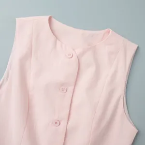 Close-up detail of a pink round neck vest featuring buttons and fabric texture