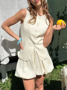 Chic off-white linen vest and bubble mini skirt set perfect for summer outdoor style.
