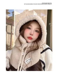 Detail of a beige knit Balaclava hood with plush lining on a model for winter.
