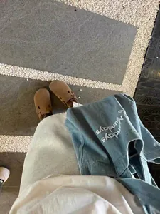 Vintage blue canvas tote bag for students shown in a lifestyle daily outfit
