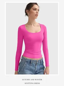 Detailed view of women's hot pink U-neck long sleeve crop top in slim fit Y2k style