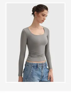 Detailed view of a women's grey U-neck slim fit long-sleeved crop top in soft fabric