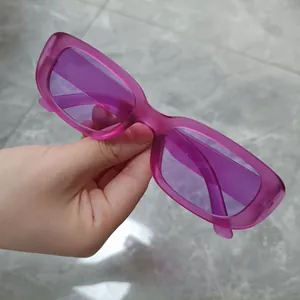 Detailed view of trendy purple small rectangular sunglasses with translucent frame