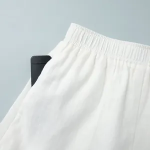 Détail d'un short blanc en lin avec une taille élastique et poche latérale pratique