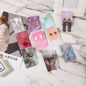 Elegant marble pattern jewelry display cards with gold foil accents for necklace sets