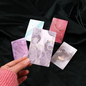 Set of marble patterned jewelry display cards with gold foil accents for earrings.