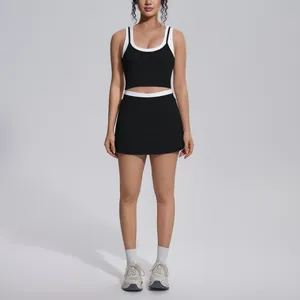 Two-piece black and white ribbed yoga set featuring crop top and high-waisted skirt