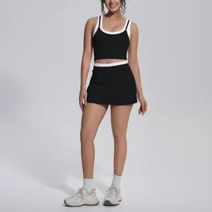 Two-piece black and white ribbed yoga set featuring a tank top and high-waisted skirt