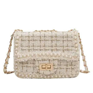 Elegant tweed crossbody bag with pearl trim and gold-tone chain strap