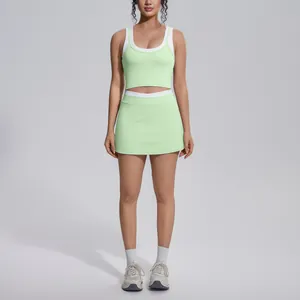 Two-piece light green and white yoga set with crop top and high-waisted tennis skirt
