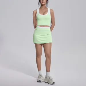 Detail of lime green yoga set featuring a contrast color racerback tank and skort.