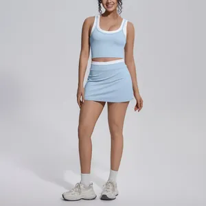 Full-body view of a two-piece light blue yoga set with contrast white trim on tank top and skort