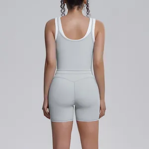 Back view of a two-piece grey ribbed high-waist yoga set with white contrast straps