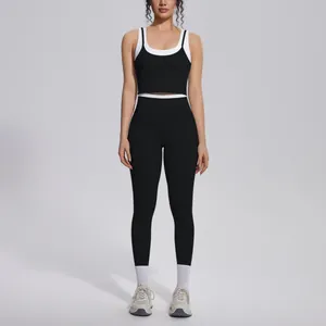 Full body view of a black and white color-blocking ribbed yoga set for women
