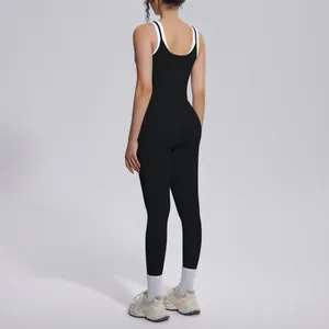 Back view of professional black yoga set with white contrast straps and high waist leggings