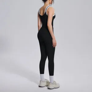 Detailed back view of a black ribbed yoga set featuring stylish white contrast trim