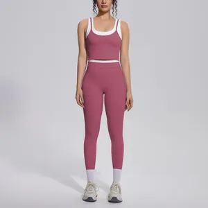 Full view of a dusty rose and white color-block high-waisted yoga set on a model