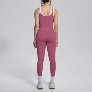 Back view of a mauve color-blocking yoga set with white trim and matching leggings set