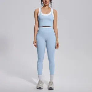 Studio shot of a light blue color block yoga set featuring high waist ribbed leggings