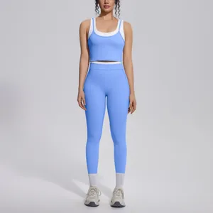 Full view of blue and white colorblock high waist yoga set shown on a fitness model