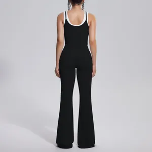 Detail showing back view of black ribbed yoga set with white trim and flared pant legs.
