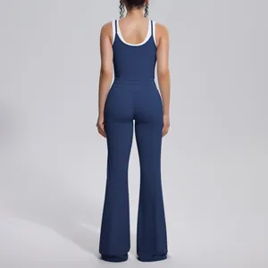 Back view of navy blue yoga set with contrast white trim and high-waisted flared pants