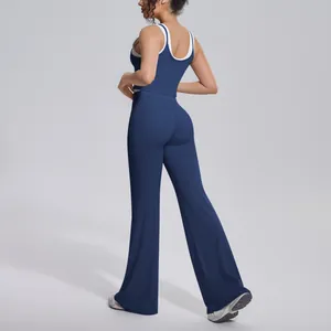Rear view showing the fit and flare of navy blue yoga pants with matching sports top