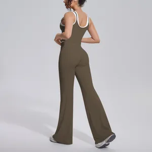Back view of a ribbed high-waist yoga set featuring a contrast color tank top and flared pants