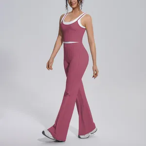 Stylish two-piece dusty rose ribbed yoga set featuring high-waist flared pants and crop top