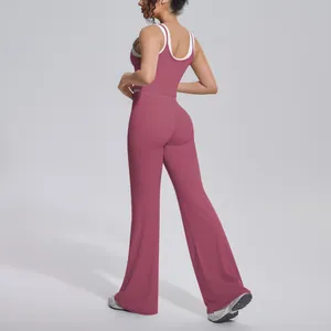 Detailed back view of pink ribbed yoga set with contrast straps and flare workout pants.
