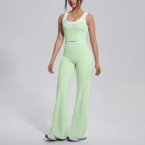 Close-up of light green two-piece yoga set featuring high-waist flared leggings and crop tank
