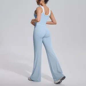 Rear view of model wearing a light blue ribbed high waist yoga set with flare pants