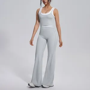 Full view of grey high-waisted yoga set with flared pants and color-block tank top