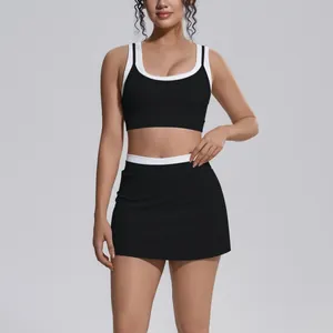 Detail of black and white color-blocking ribbed yoga set with high-waist sports skirt
