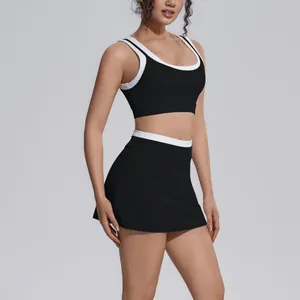 Detailed view of women's black and white contrast ribbed yoga set with tennis skirt