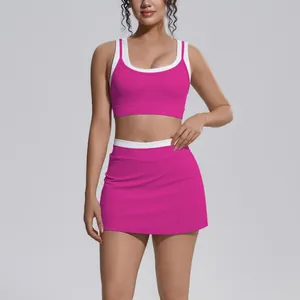 Close-up of fuchsia and white ribbed yoga set featuring a sports bra and high-waist skirt
