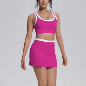 Two-piece hot pink yoga set with white trim featuring a sports bra and high-waist skirt