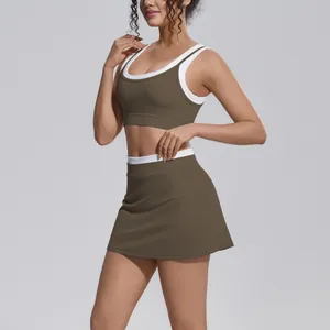 Detail view of the olive green and white color-blocking high-waisted sports skirt and top.