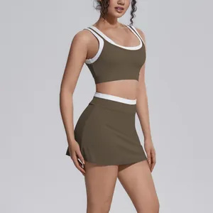 Detail view of two-piece olive green yoga set with white ribbed trim and high-waist skirt