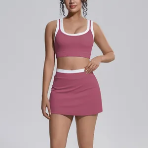 Two-piece ribbed high-waisted yoga skirt set with color-block crop top for fitness.
