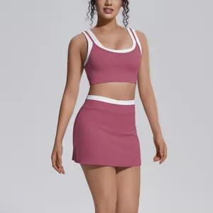 Front view of a pink two-piece yoga set with white trim, sports bra and high-waist skirt