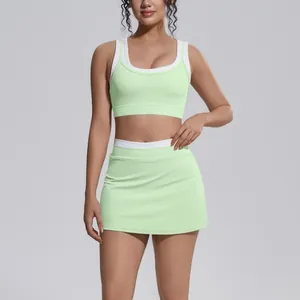 Professional studio shot of a mint green ribbed athletic two-piece yoga set for women.