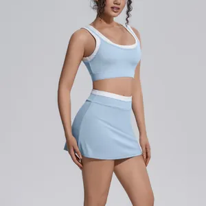 Detail shot of a light blue two-piece yoga skort set with a color-block sports bra.