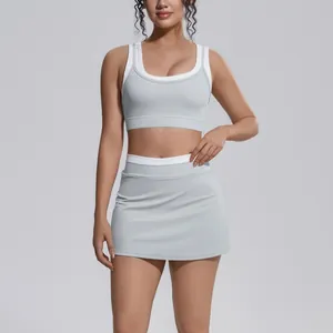 Close-up of color-block yoga set featuring a sports bra and high-waist tennis skirt.