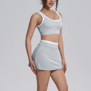Detailed view of gray color-block yoga sports bra and matching high-waisted skort set