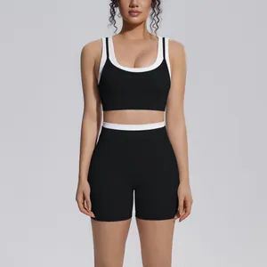 Front view of professional black and white contrast ribbed high waist yoga set for women