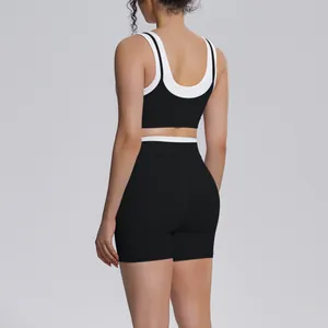 Back view of a black and white ribbed yoga set with high-waisted shorts and sports bra.
