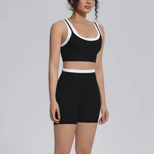 Detailed front view of women's black and white contrast ribbed yoga set on model