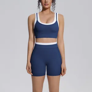 Two-piece navy blue ribbed yoga set with white contrast trim and high-waist shorts
