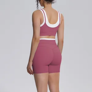 Back view of dusty rose yoga set with white trim, featuring high-waisted sports shorts.